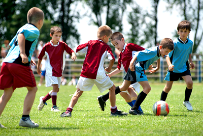 Children playing soccer during a sports activity