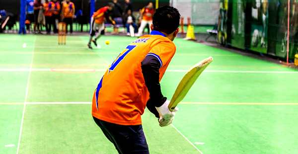 Cricket player batting in an indoor game