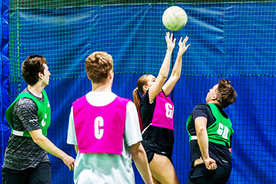 Netball player shooting towards the goal