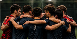 Players joining together in a team huddle