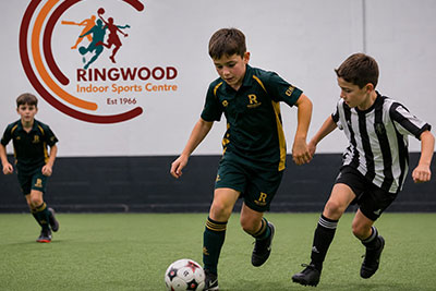 Junior soccer player controlling the ball indoors